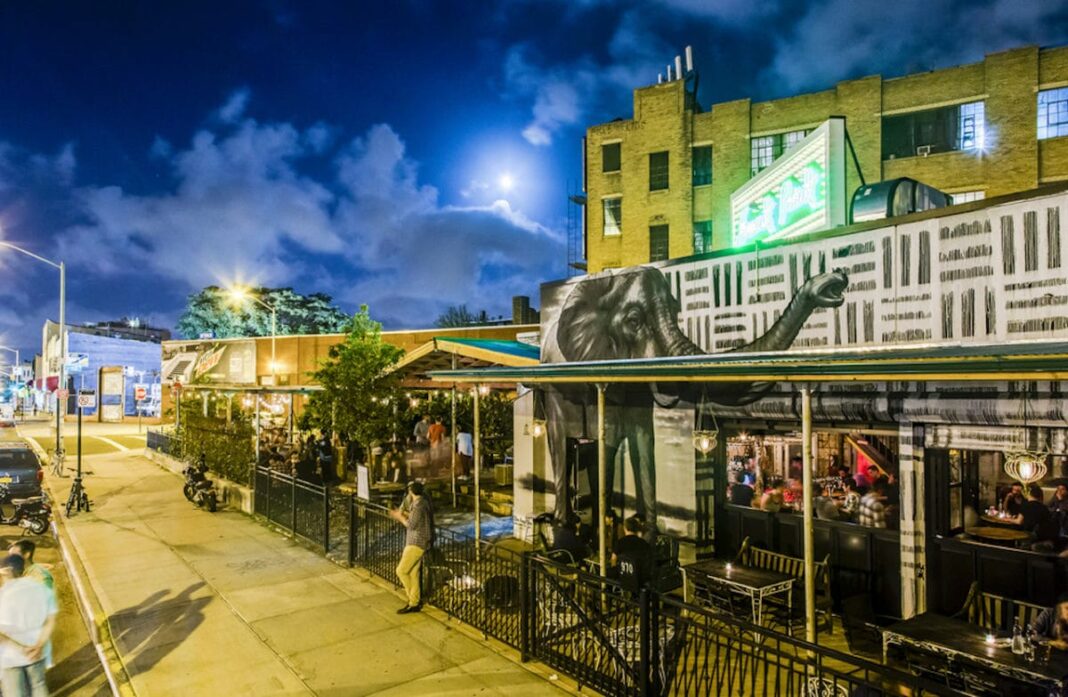 Outside shot of people sitting and drinking on outdoor patio