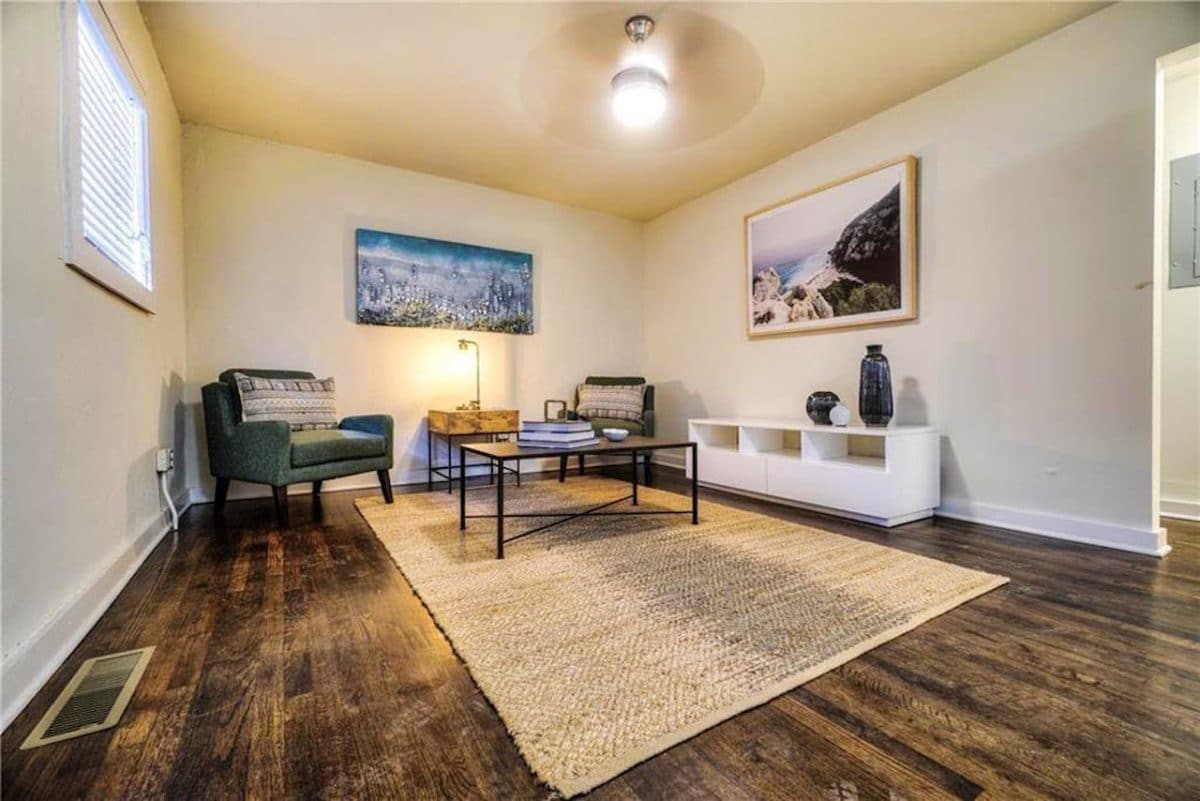 hardwood floor living room with chairs and table