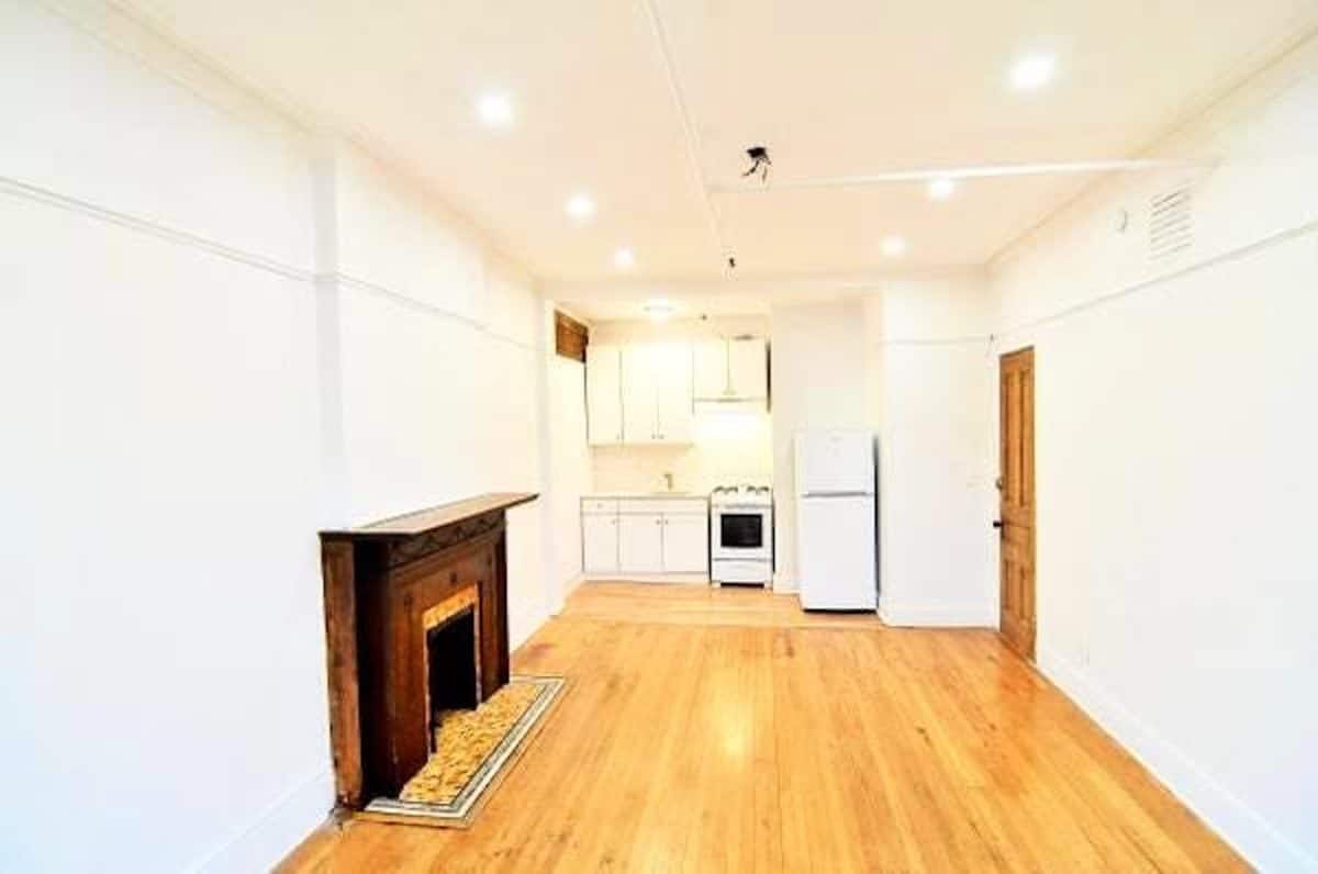 empty living room facing the kitchen