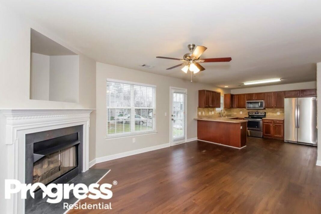 harwood floored living room with breakfast bar and kitchen in the background
