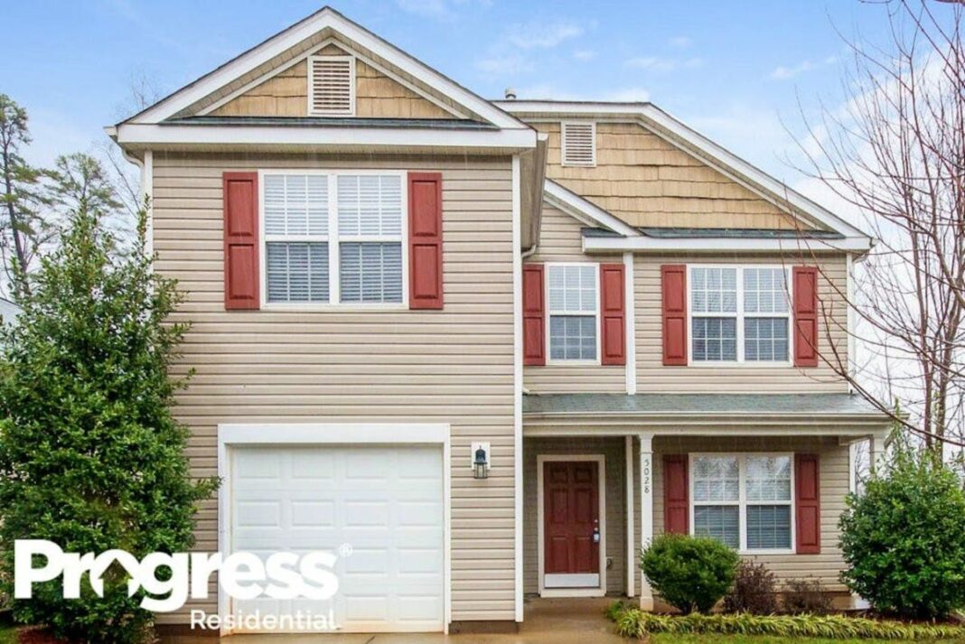 front of red and beige two-story house 