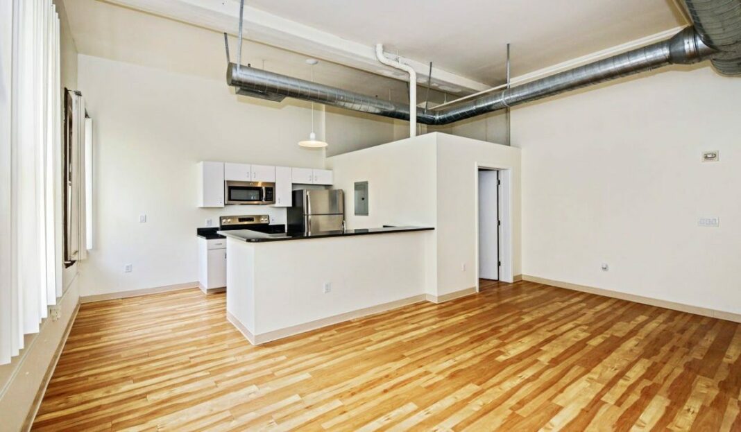 lofted living room with high ceilings and kitchen