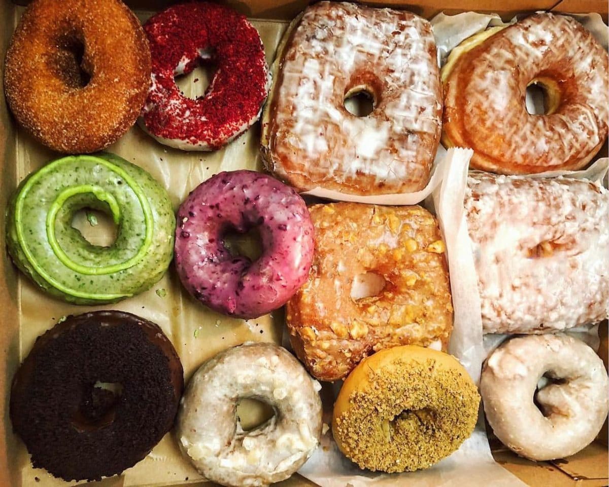 aerial shot of a dozen donuts, multi-colored