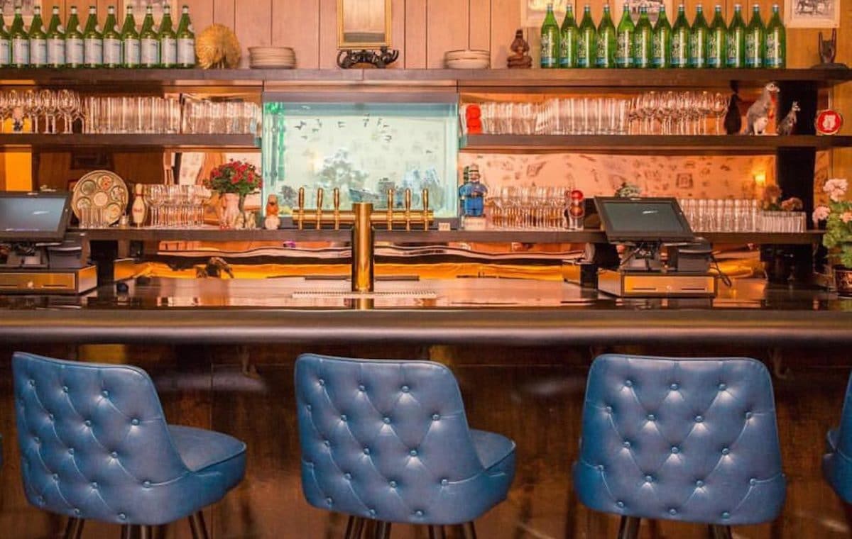 empty bar with leather seats and wood bar top
