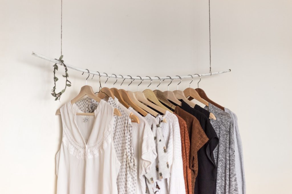 Boutique shop with dresses and women's clothing hanging from rod