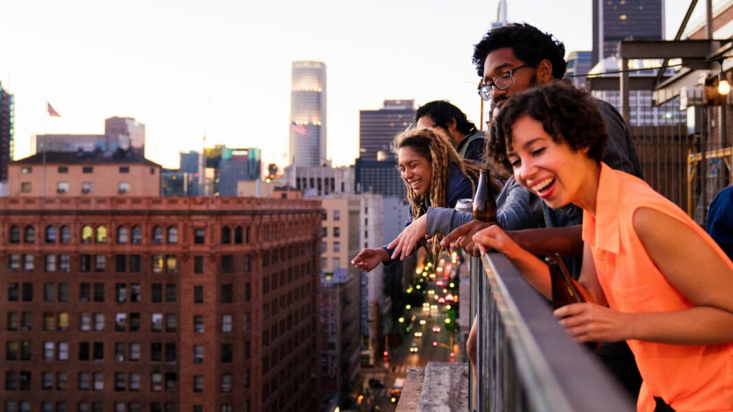 Group of friends hanging out together on a balcony in downtown Los Angeles